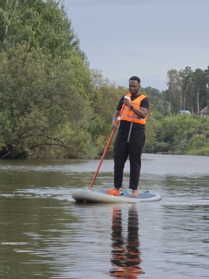 Stand-up paddleboarding. Still dry. Mostly.